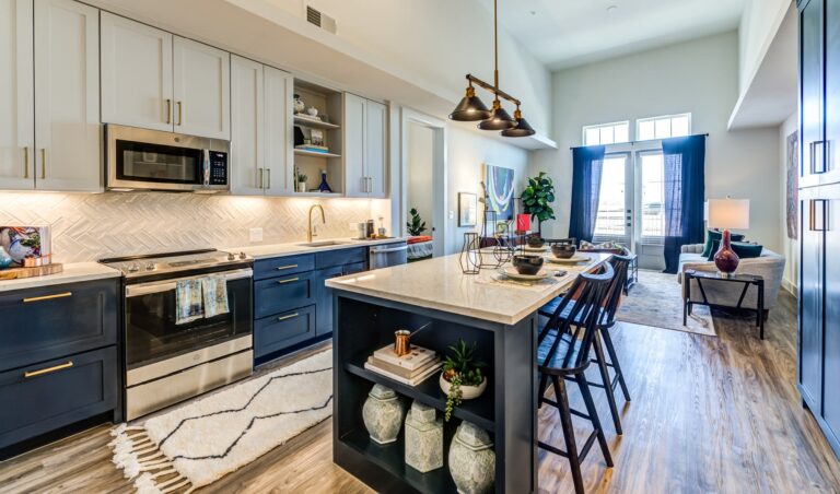 Modern luxury kitchen with marble countertops and custom wooden cabinets in a Frisco, Texas home
