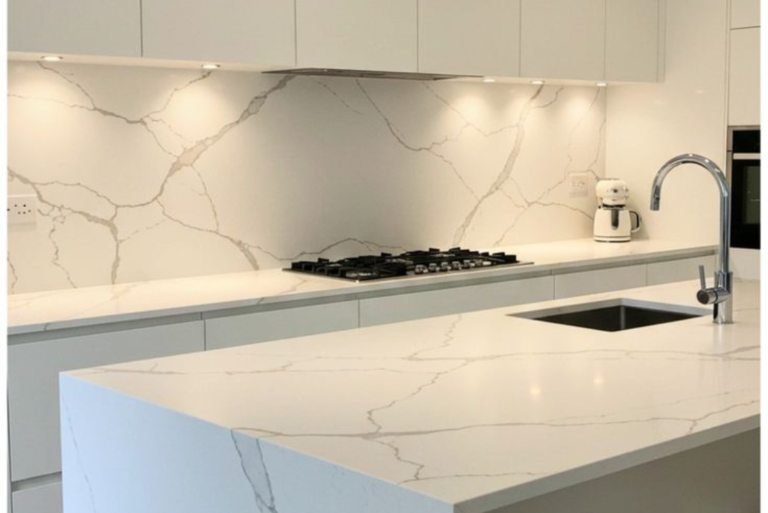 Quartz backsplash installation in a modern luxury kitchen in Frisco TX with seamless quartz slab design